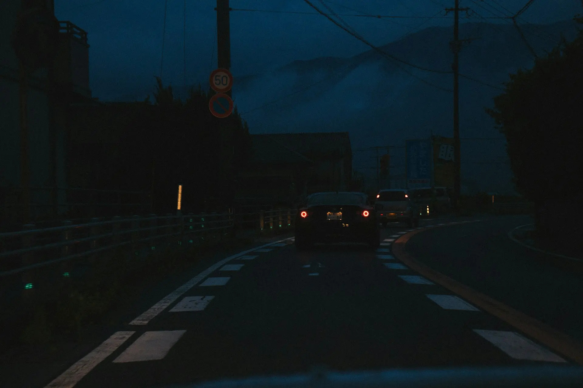 a car driving down a street at night
